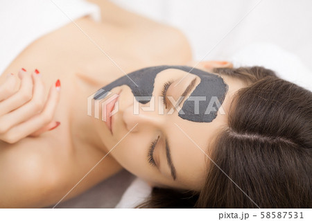 Woman in mask on face in spa beauty salon. 58587531