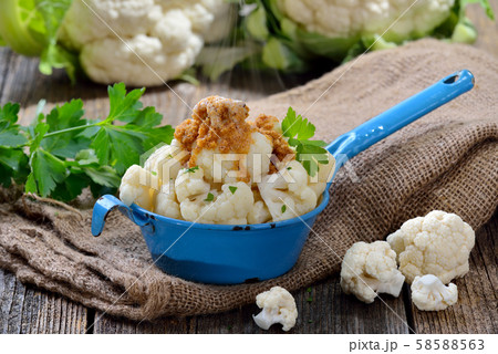 Cooked cauliflower bread crumbs browned in butter and served steaming hot  in an old enamel pot 58588563