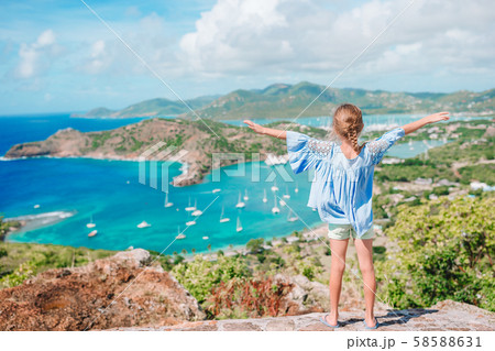 Adorable little kid enjoying the view of picturesque English Harbour at Antigua in caribbean sea 58588631