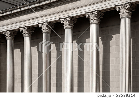 Vintage Old Justice Courthouse Column. Neoclassical colonnade with corinthian columns as part of a 58589214