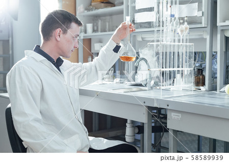 scientist conducts chemical experiments with liquids in the medical laboratory 58589939