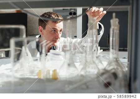 scientist conducts chemical experiments with liquids in the medical laboratory 58589942