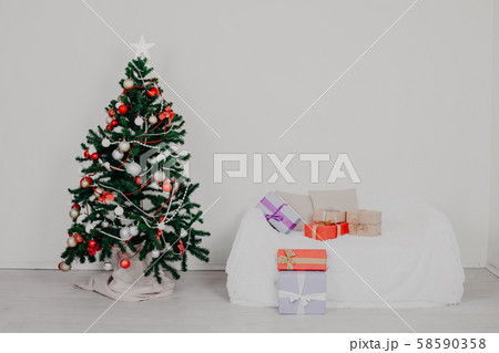 Christmas tree in the room with Christmas decorations and gifts toys Christmas tree in the room with Christmas decorations and gifts toys 58590358