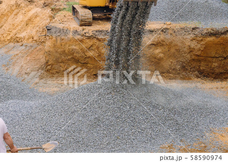 A excavator in a working to gravel construction A excavator in a working to gravel construction 58590974