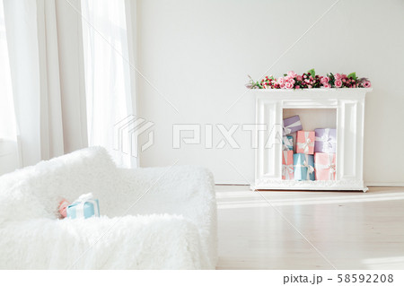 white sofa and table with gifts and flowers in the interior white sofa and table with gifts and flowers in the interior 58592208