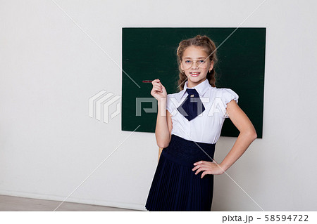 Beautiful schoolgirl girl at the board in class in class 58594722