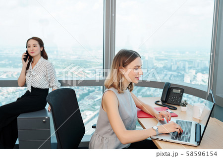 Businesswoman answering e-mails Businesswoman answering e-mails 58596154