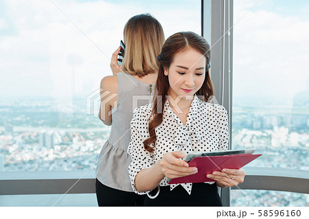 Young businesswoman reading article online Young businesswoman reading article online 58596160