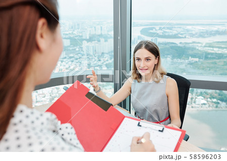 Entrepreneur giving orders to secretary 58596203