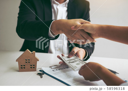Home sales agents and buyers work on signing new 58596318