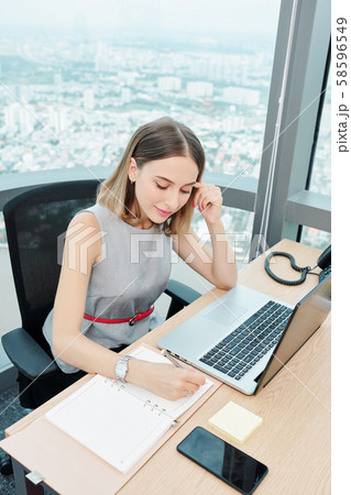 Smiling businesswoman planing day 58596549