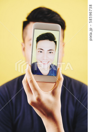 Cheerful man taking selfie 58596738
