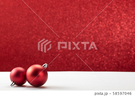 christmas balls on white table red wall 58597046