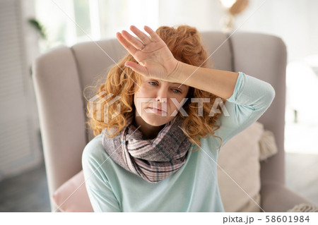 Woman suffering from headache and high body temperature 58601984