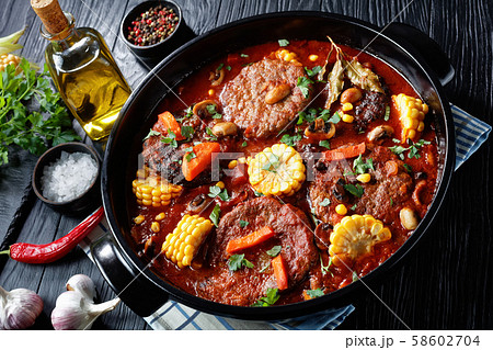 Burgers in marinara sauce with corn cobs Burgers in marinara sauce with corn cobs 58602704