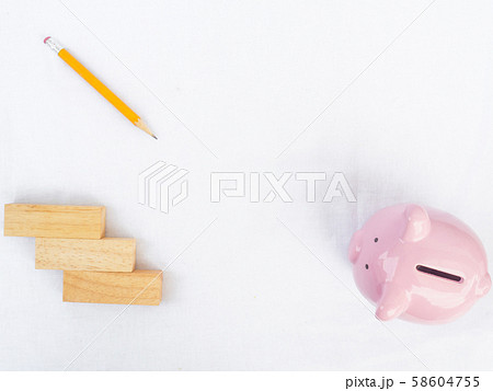 Pink piggy bank on white background with wooden block and yellow pencil, Drawing own way to saving money for future plan and retirement fund concept 58604755
