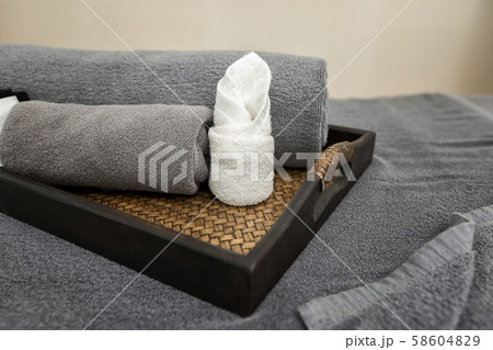 Towel in basket on massage table in modern spa salon.  58604829