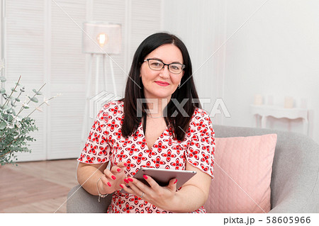 Portrait of a brunette woman in a red and white 58605966