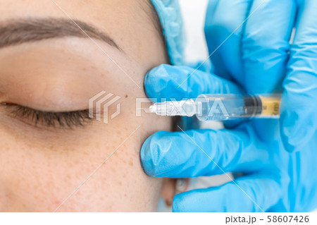 Close-up, beautician makes beauty injections into Close-up, beautician makes beauty injections into 58607426