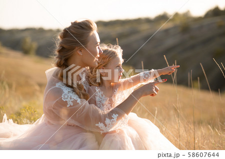 Young mother with a little daughter in pink Young mother with a little daughter in pink 58607644