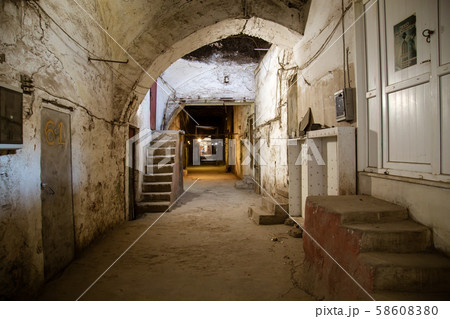 Old abandoned tunnel in the slum underground cellar. Entrance to urban catacombs. Underside of city Old abandoned tunnel in the slum underground cellar. Entrance to urban catacombs. Underside of city 58608380