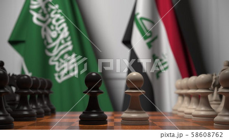 Flags of Saudi Arabia and Iraq behind pawns on the chessboard. Chess game or political rivalry 58608762