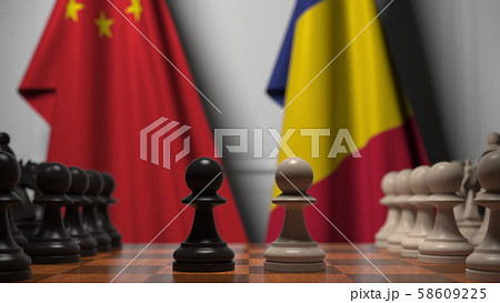 Flags of China and Romania behind pawns on the chessboard. Chess game or political rivalry related Flags of China and Romania behind pawns on the chessboard. Chess game or political rivalry related 58609225