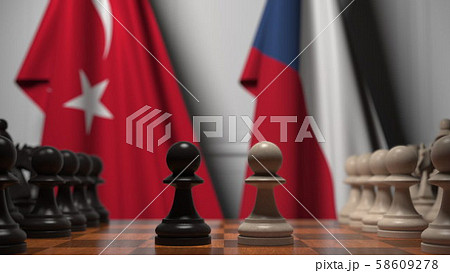 Flags of Turkey and the Czech Republic behind pawns on the chessboard. Chess game or political Flags of Turkey and the Czech Republic behind pawns on the chessboard. Chess game or political 58609278