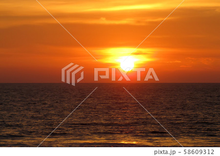beautiful red sunset over the ocean. Bright sunset with large yellow sun under the sea surface 58609312