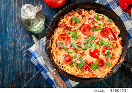Frittata made of eggs, sausage chorizo, red 58609554