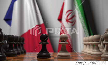 Flags of France and Iran behind pawns on the chessboard. Chess game or political rivalry related 3D 58609600