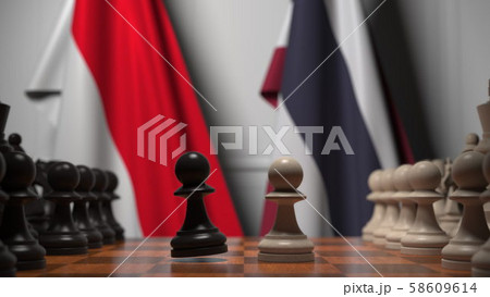 Flags of Indonesia and Thailand behind pawns on the chessboard. Chess game or political rivalry 58609614