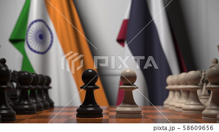 Flags of India and Thailand behind pawns on the chessboard. Chess game or political rivalry related 58609656