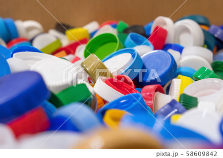 Plastic garbage background. Plastic caps of different colors. Risk of health for humans and Plastic garbage background. Plastic caps of different colors. Risk of health for humans and 58609842