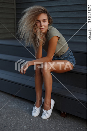 Pretty young stylish sexy woman with curly hair Pretty young stylish sexy woman with curly hair 58612879