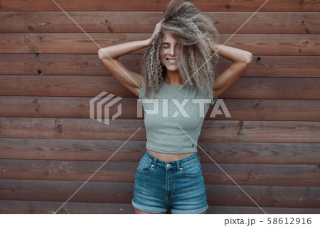 Happy beautiful funny young curly girl  58612916