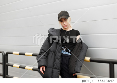Beautiful young woman in a stylish black cap  58613847