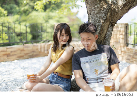 別荘の庭でビールを飲むカップル 別荘の庭でビールを飲むカップル 58616052