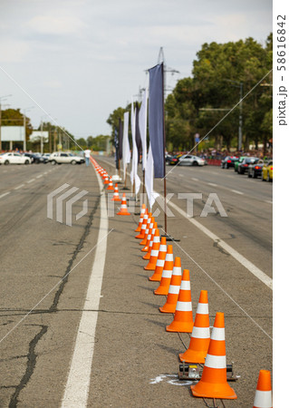 orange traffic cones in the middle of the road. orange traffic cones in the middle of the road. 58616842