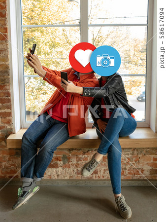 Creative millenial people connecting and sharing social media. Modern UI icons as heads Creative millenial people connecting and sharing social media. Modern UI icons as heads 58617094