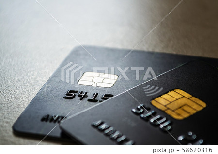 Two black credit cards with chips and contactless pay technology close-up. 58620316