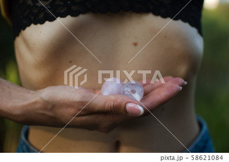 Female hands holding two yoni eggs for vumfit, imbuilding or meditation are made from pink quartz Female hands holding two yoni eggs for vumfit, imbuilding or meditation are made from pink quartz 58621084