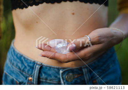 Female hands holding two yoni eggs for vumfit, imbuilding or meditation are made from pink quartz Female hands holding two yoni eggs for vumfit, imbuilding or meditation are made from pink quartz 58621113