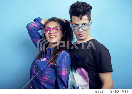happy couple together posing cheerful on blue background , guy and girl students together friends 58622911