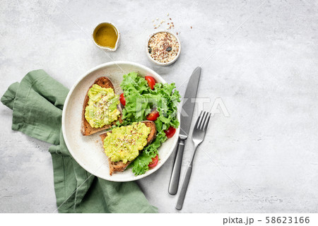 Avocado toast and kale tomato salad 58623166