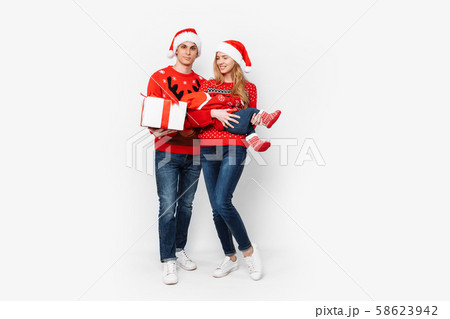 Happy family in Santa hats, mom dad and little Happy family in Santa hats, mom dad and little 58623942