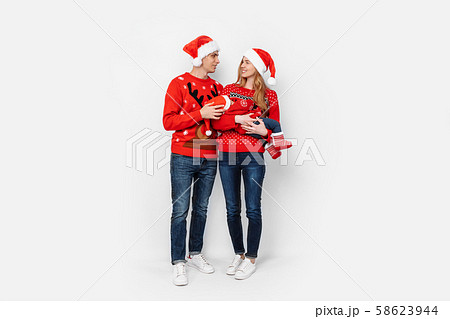 Happy family in Santa hats, mom dad and little Happy family in Santa hats, mom dad and little 58623944