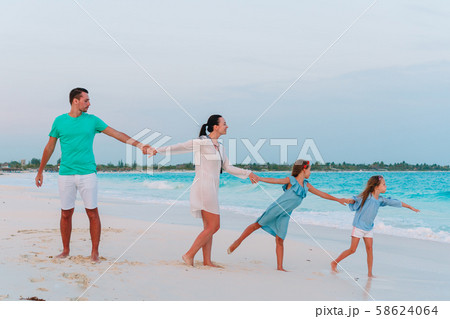 Happy family on the beach during summer vacation Happy family on the beach during summer vacation 58624064