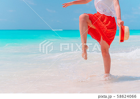 Close up of female feet on white sand beach Close up of female feet on white sand beach 58624066