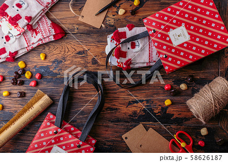 Gift boxes wrapped in red checked paper and the contents of a workspace composed. Flat lay 58626187